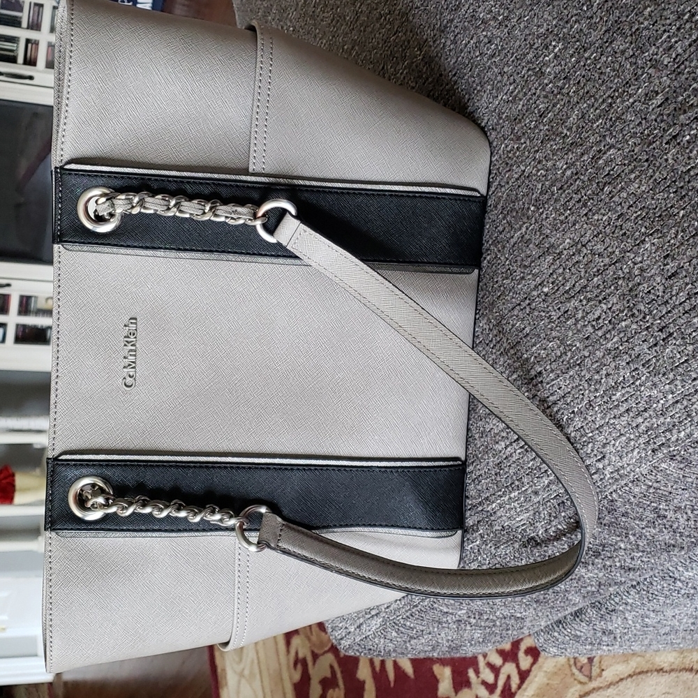 Calvin Klein gray with black tote style pocketbook with magnetic closure.